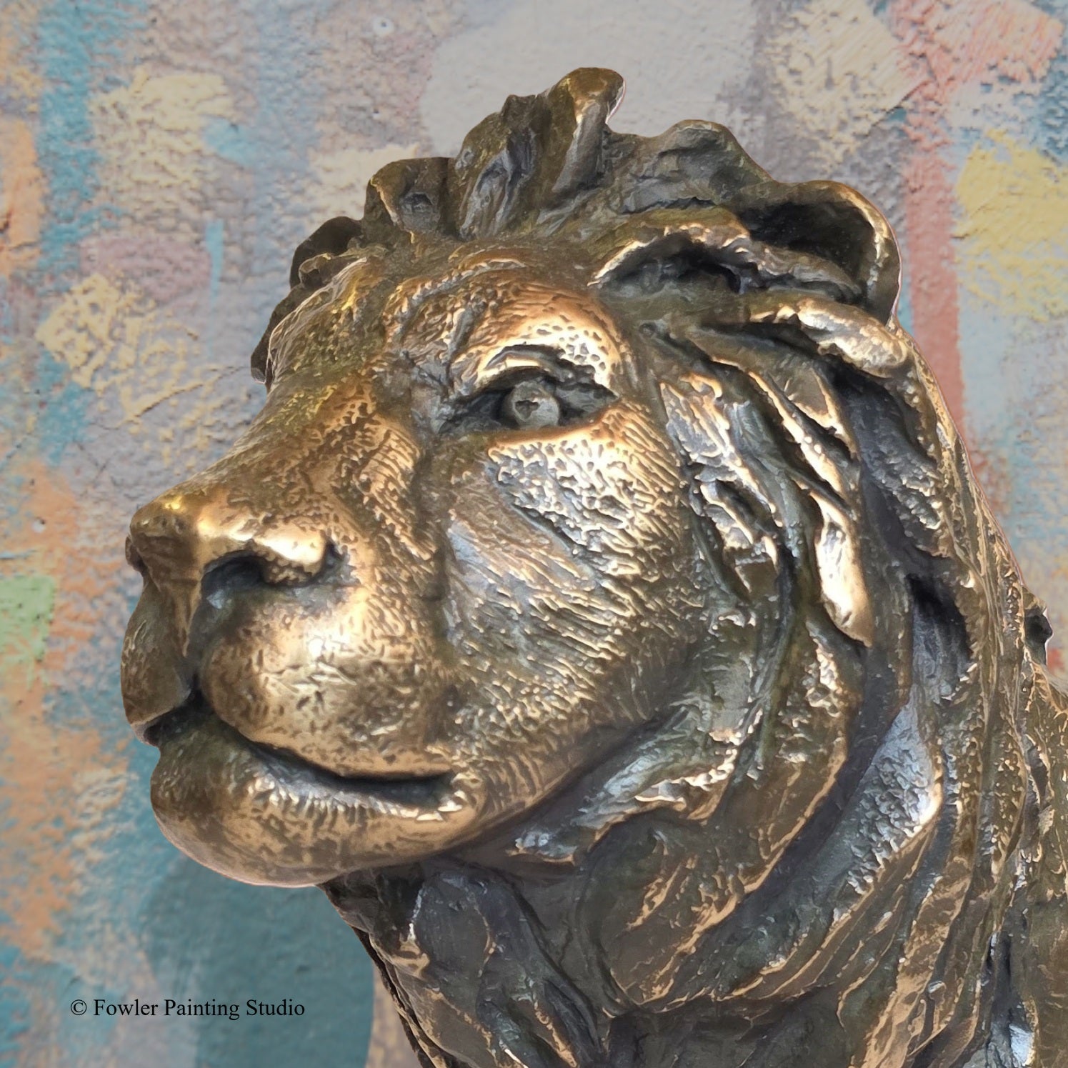 A portrait view of a bronze sculpture of a Desert Lion, by artist Jon Fowler. © Fowler Painting Studio.