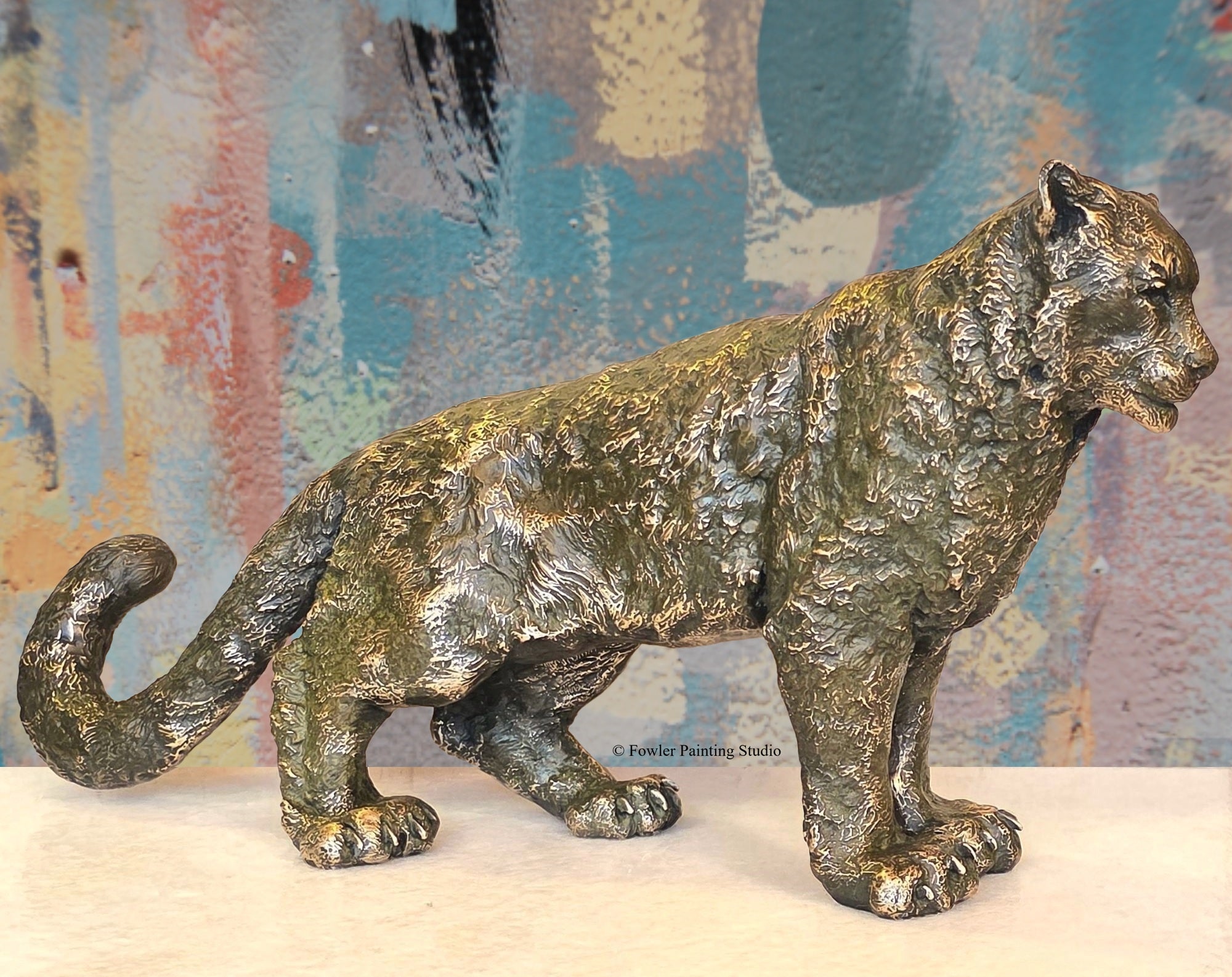 A bronze sculpture of a Mountain Snow Leopard, by artist Jon Fowler. © Fowler Painting Studio.