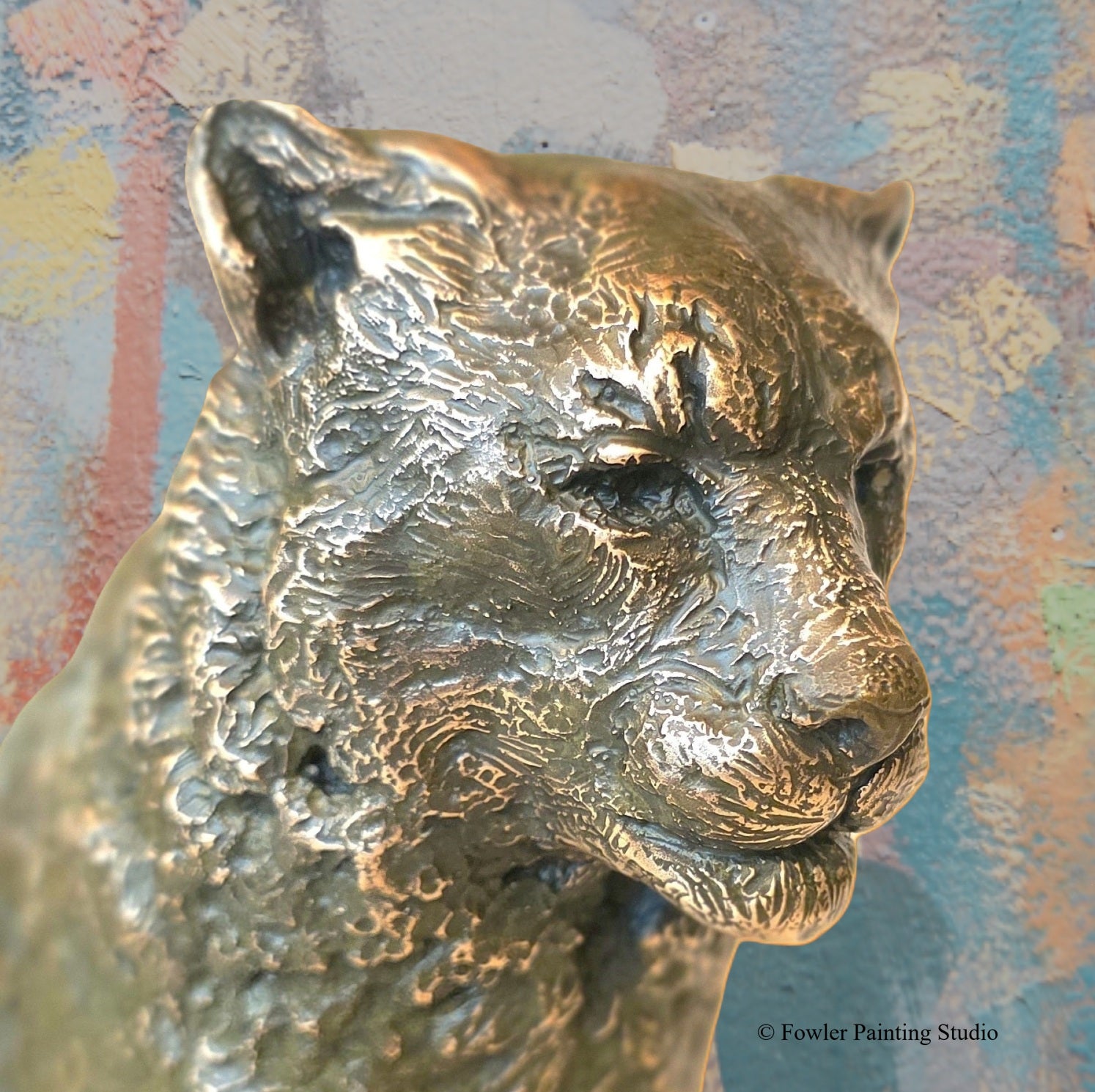A portrait view of a bronze sculpture of a Mountain Snow Leopard, by artist Jon Fowler. © Fowler Painting Studio.