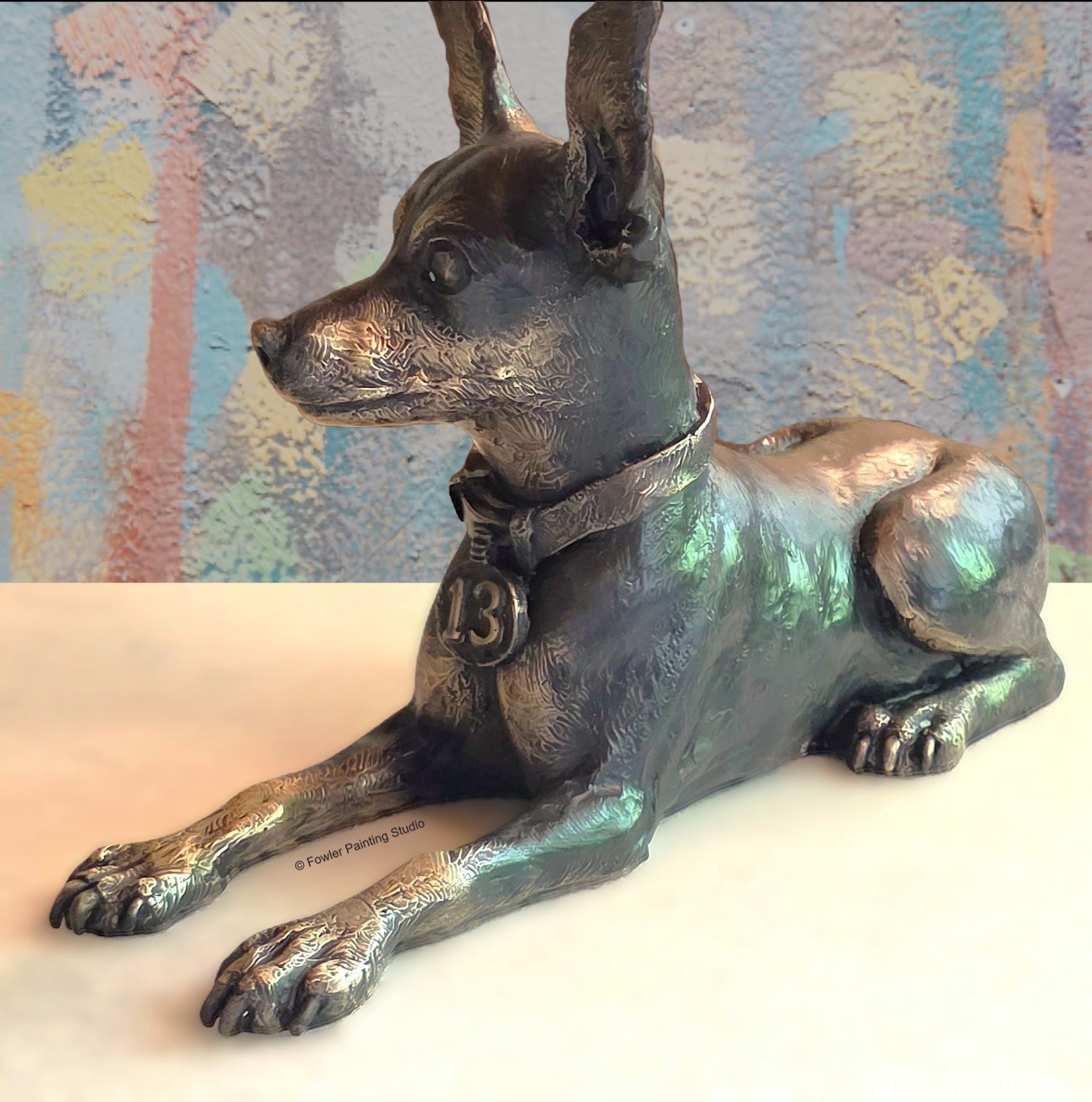 A bronze sculpture of a smalll dog, by artist Jon Fowler. © Fowler Painting Studio.